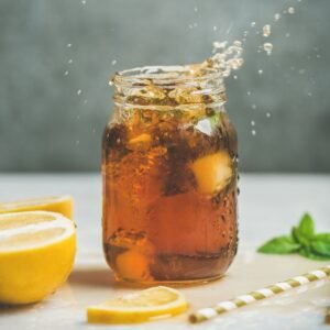 iced tea with fresh herbs in jar with splashes